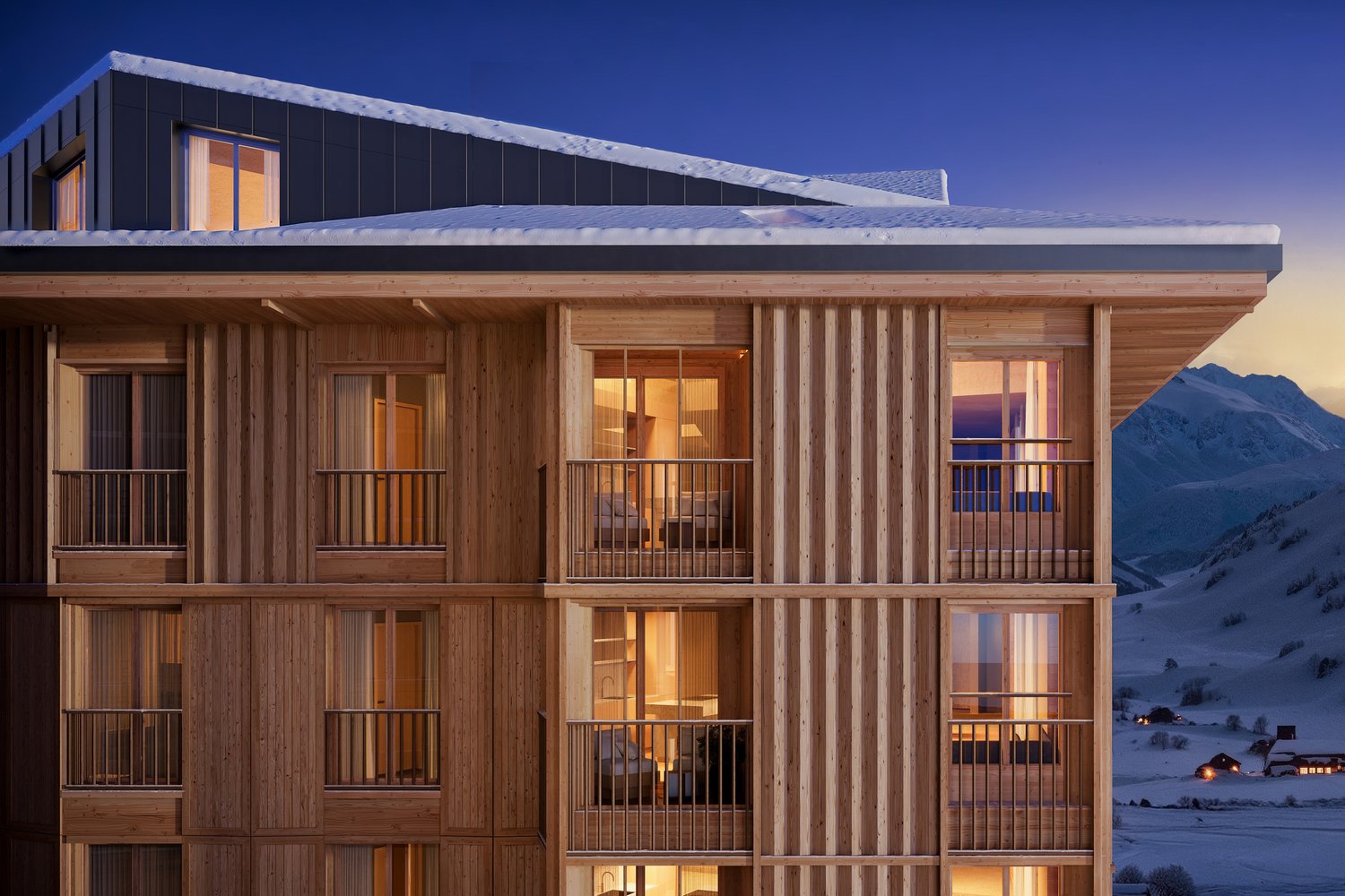 Fassade des MFH Tova in Andermatt in der Nacht