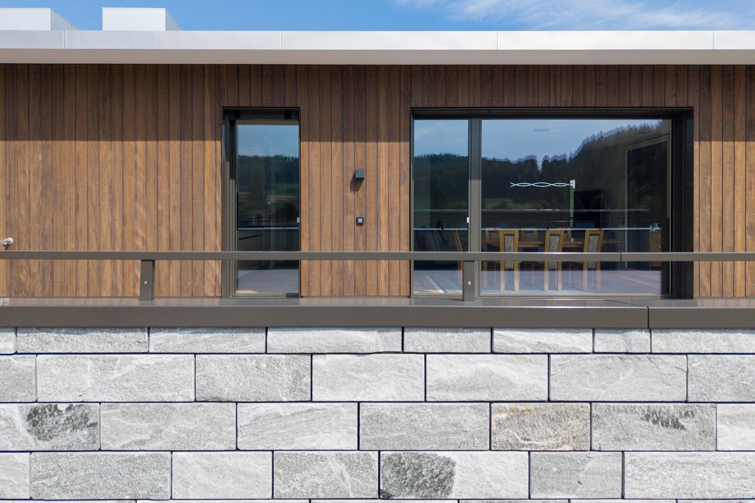 Detail Holzfassade und Steinfassade