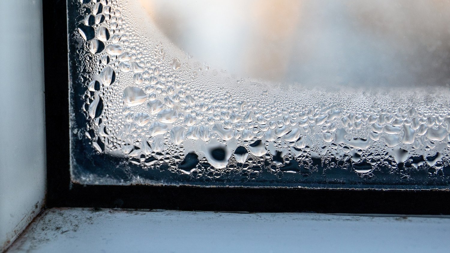 Angelaufenes Fenster mit Wassertropfen
